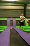 Boy Playing Trampoline Dodgeball Throwing Ball